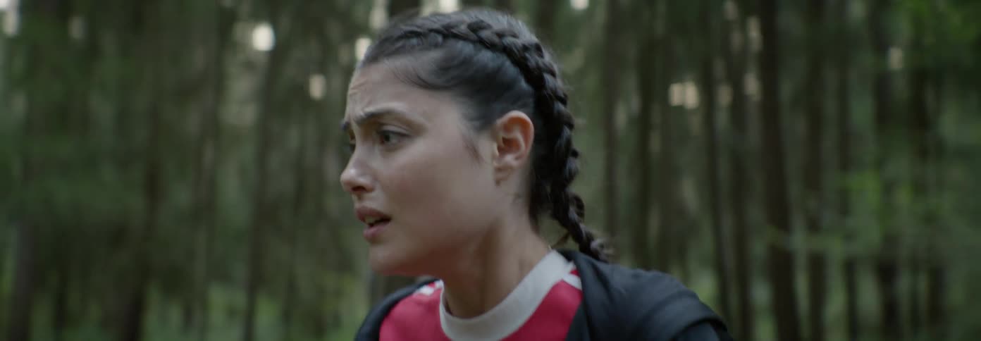 Woman panics while standing in a forest