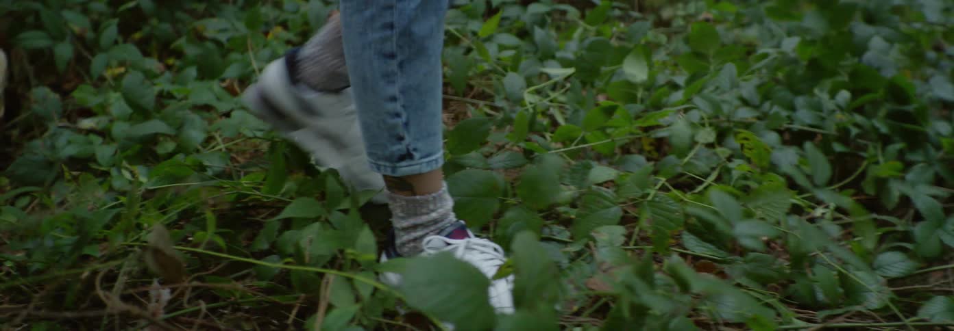 A woman falls back on a chair in the woods