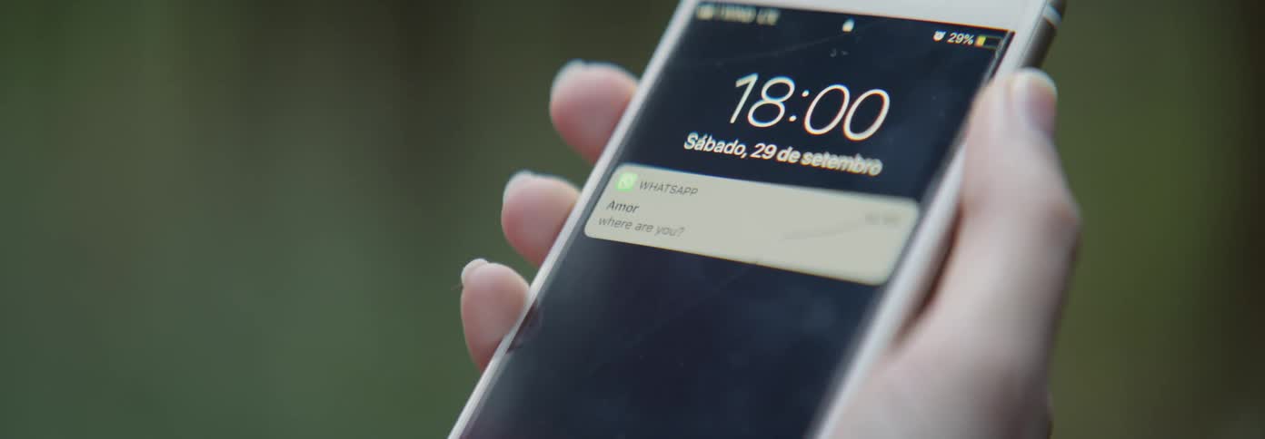 A person lifts up their phone