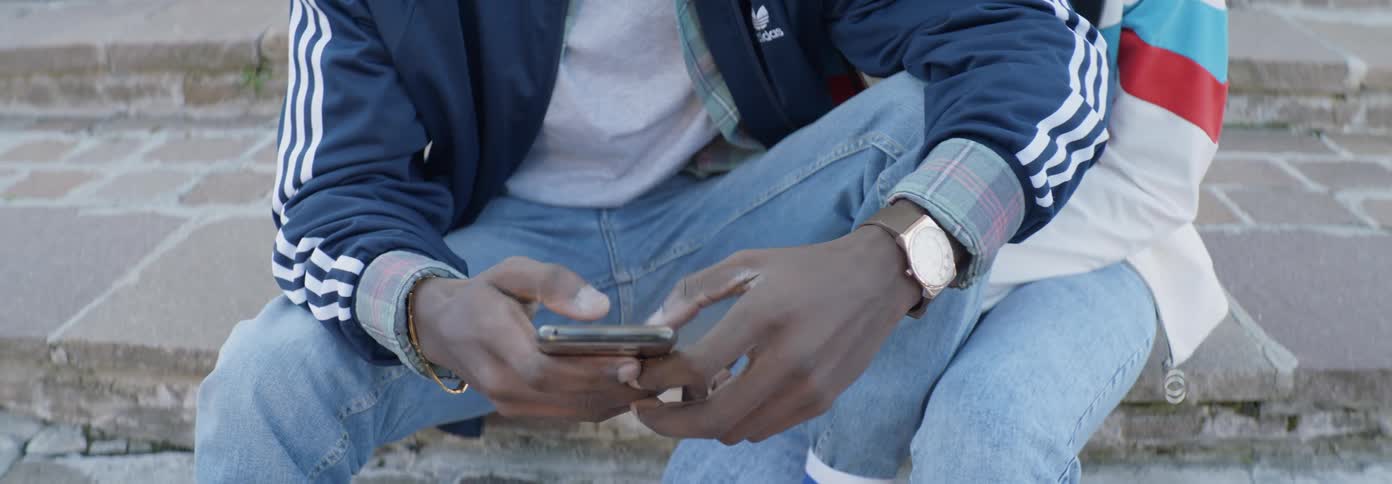 Man types on a smartphone