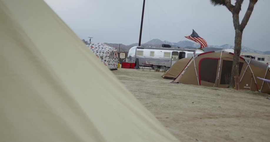 The wind is blowing the flag on the tent ahead
