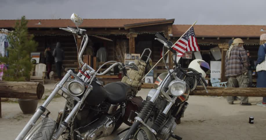 An american flag flies as it is attached to a motorcycle