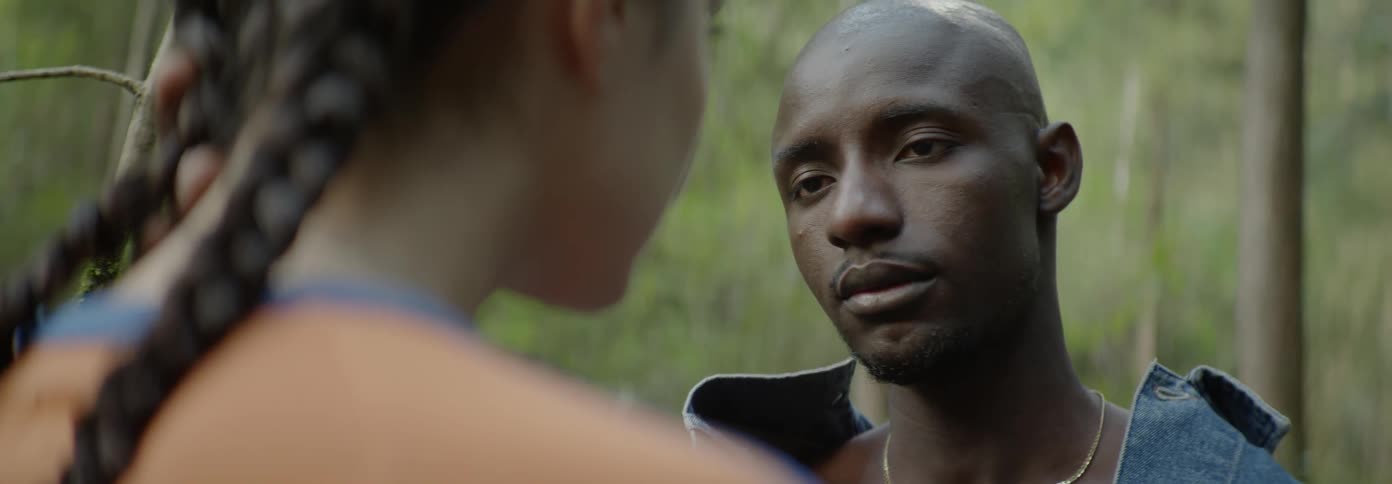 A man is talking with a woman outside