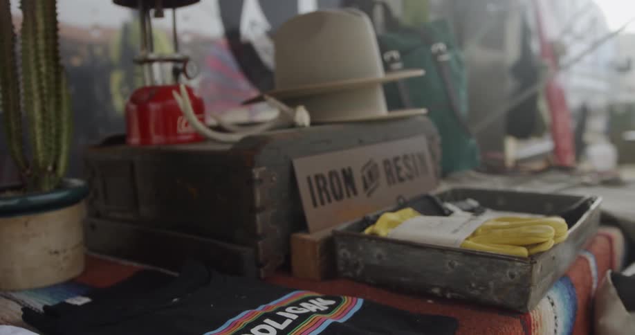 The table is filled with different items, and clothing