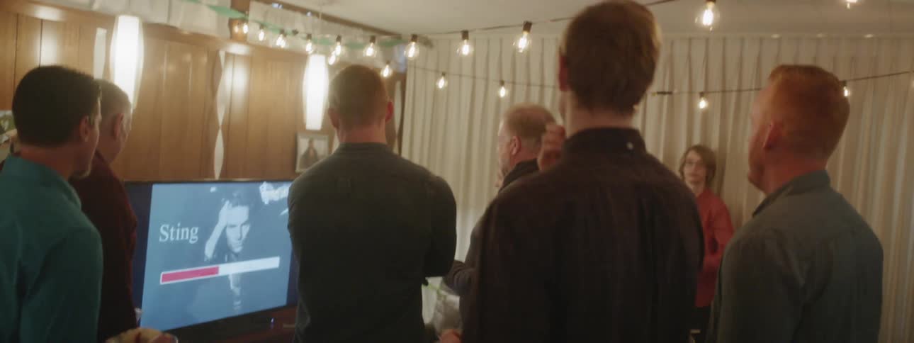 A group of people get ready for karaoke at a party