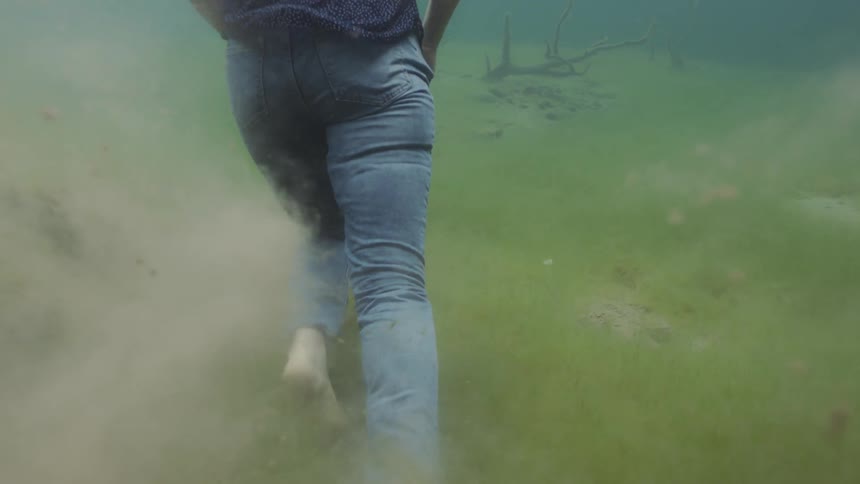 Man runs barefoot in a field