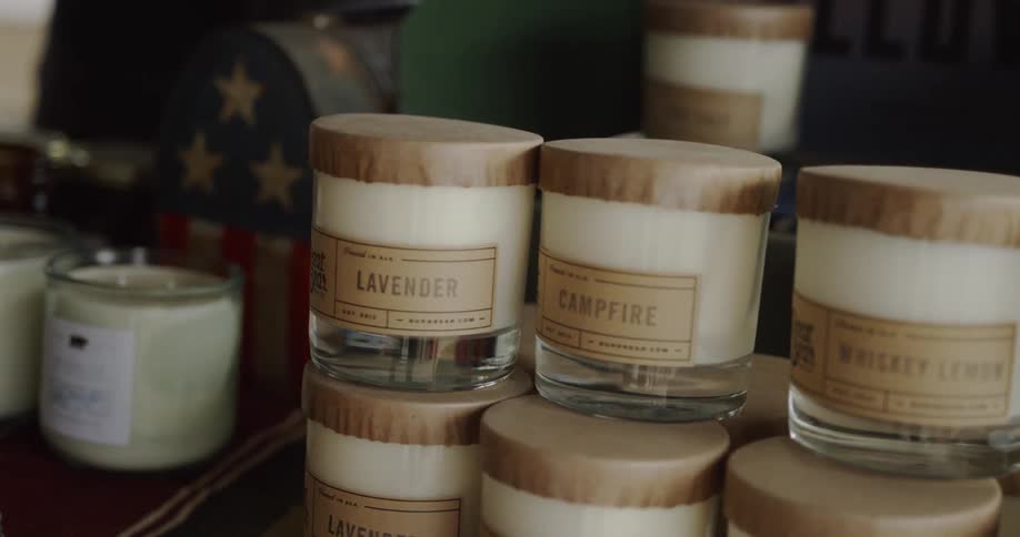 Candles are stacked on a shelf