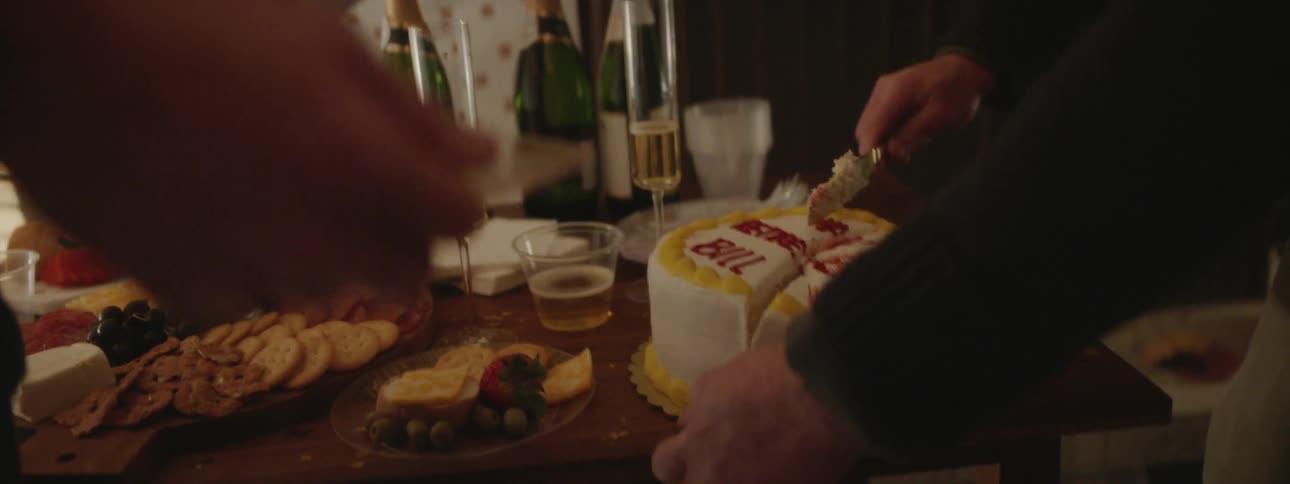 People cut cake at a party