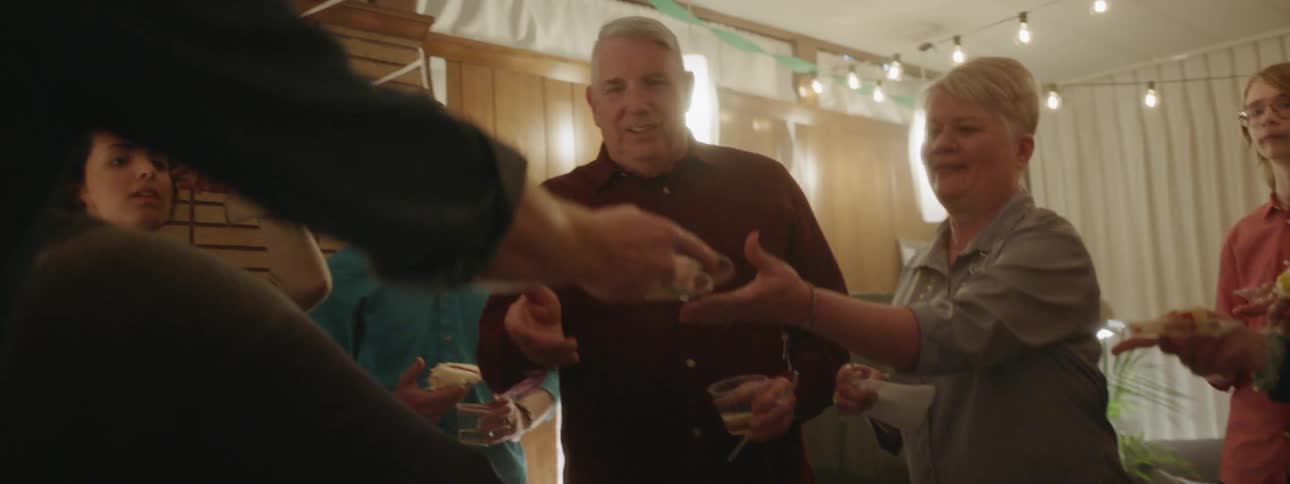 People eat cake at a retirement party