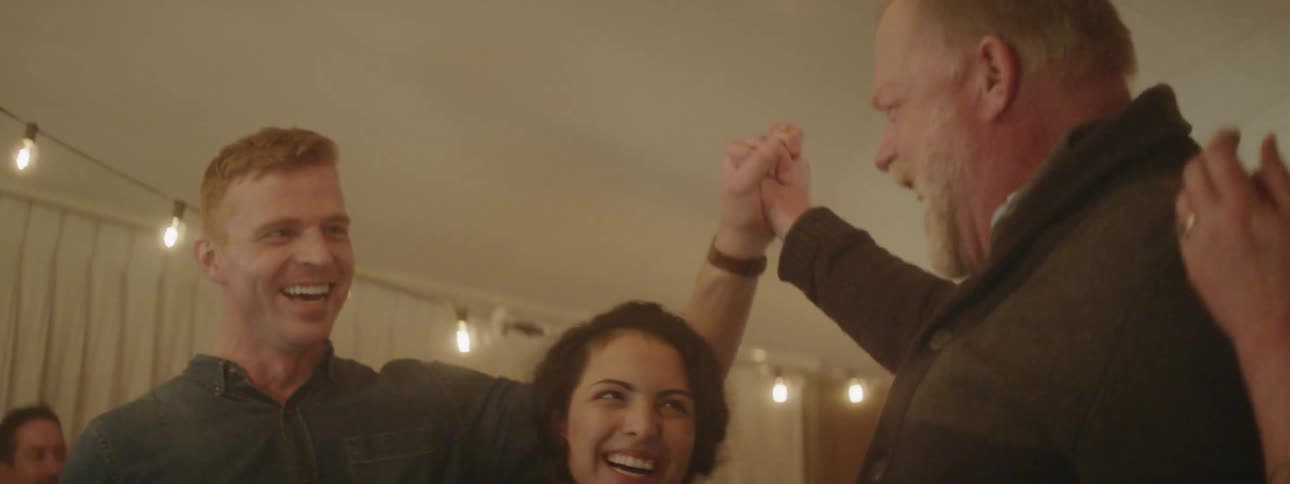 People at a party smile and high five