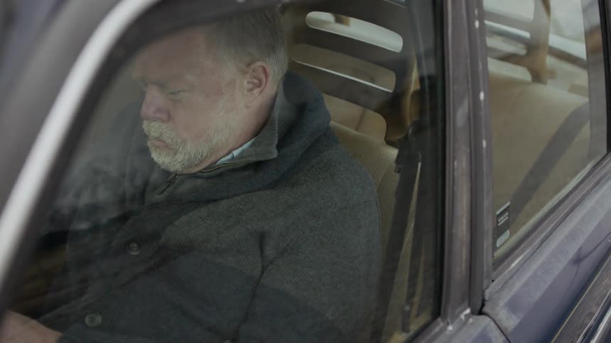 Man sitting in car