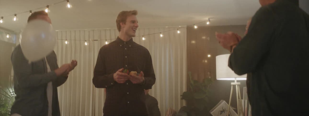 People at house party smile and clap