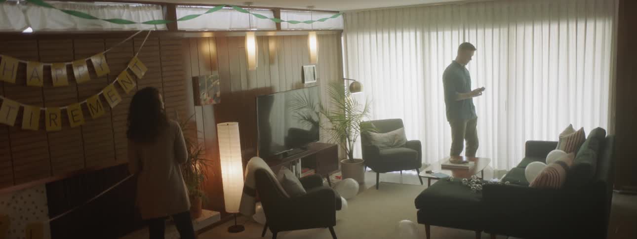 The man gets off the phone and walks out of the room