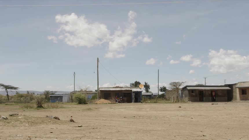 Clouds float above rural buildings