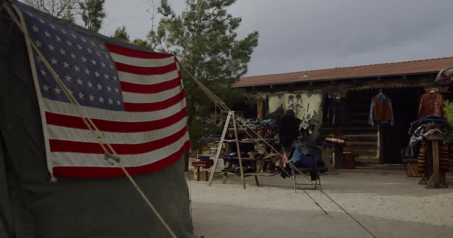 An american flag hangs outside on a wall