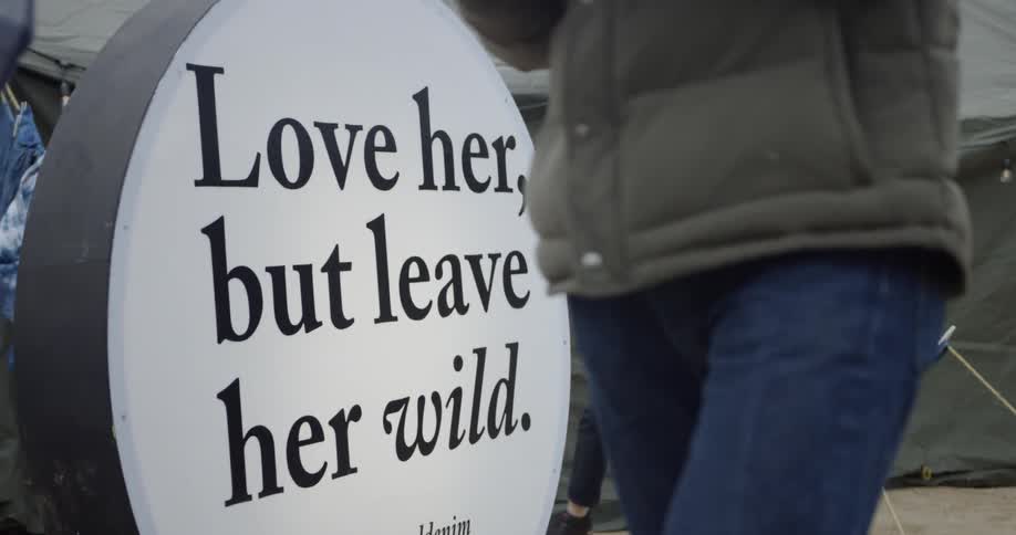 People walk past the circular sign