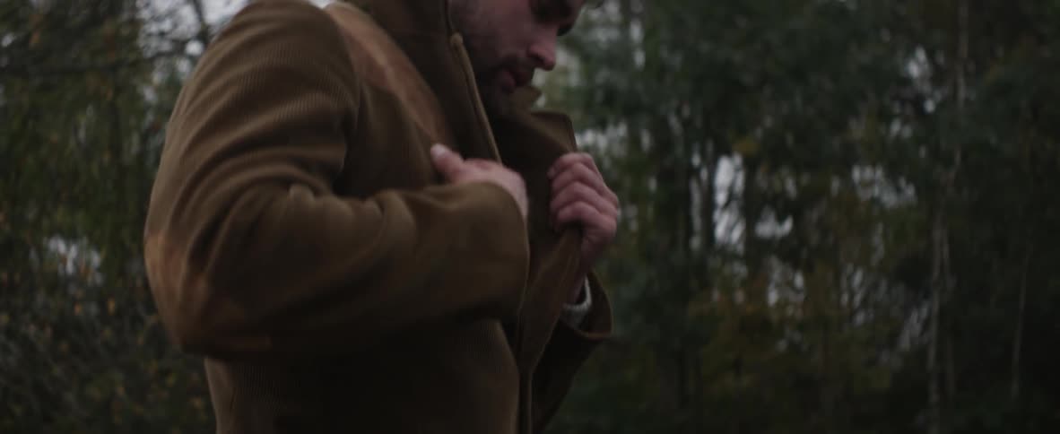 A man walking outside near trees