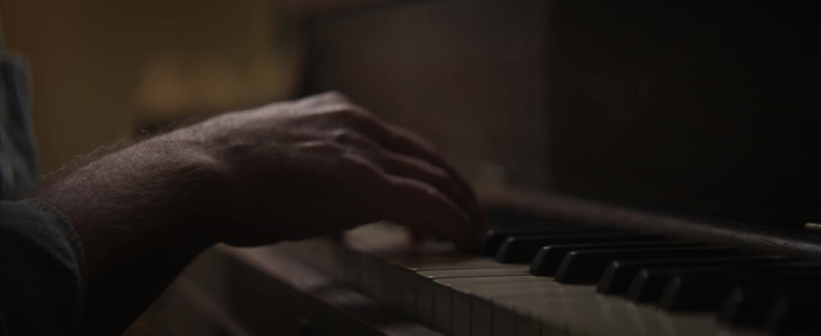 Single hand on piano keys