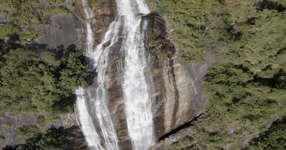 The wide waterfall splashes below
