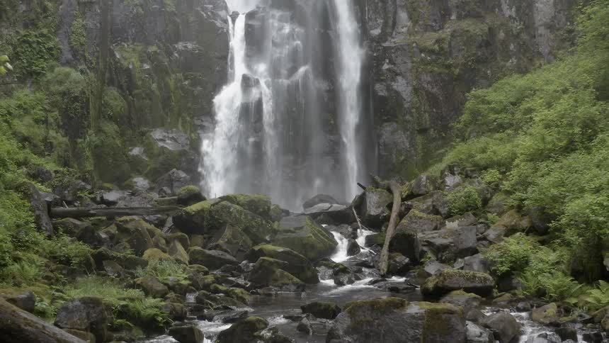 A cascade splashes down into a rocky stream below