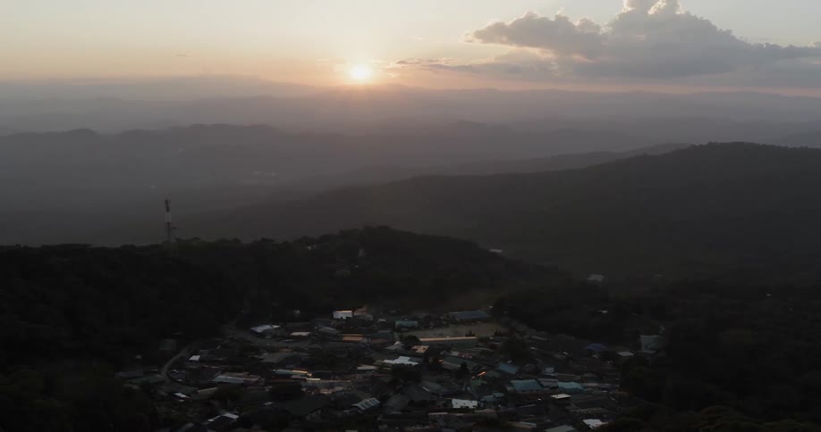 The sun sets over a mountain town