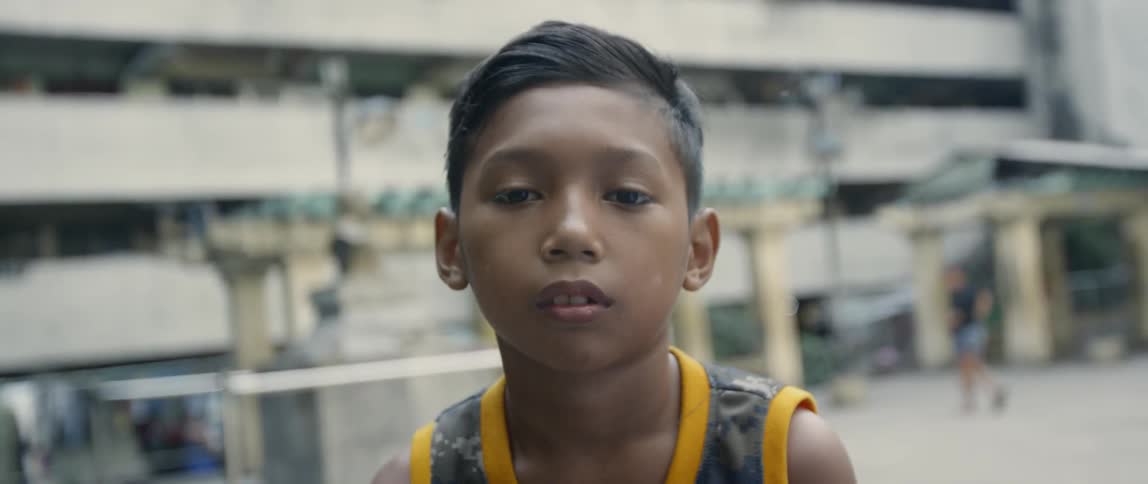 Boy stands in an apartment complex