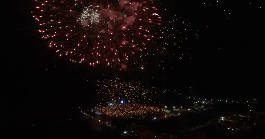 The fireworks explode in the night sky
