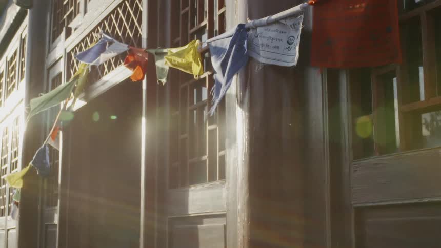A string of banners hangs on a building