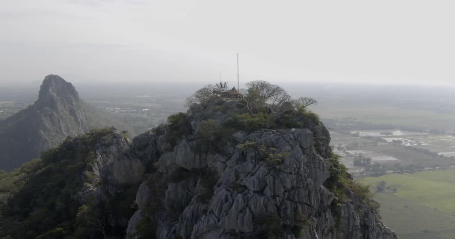 Trees sit on the mountain under a cloudy sky