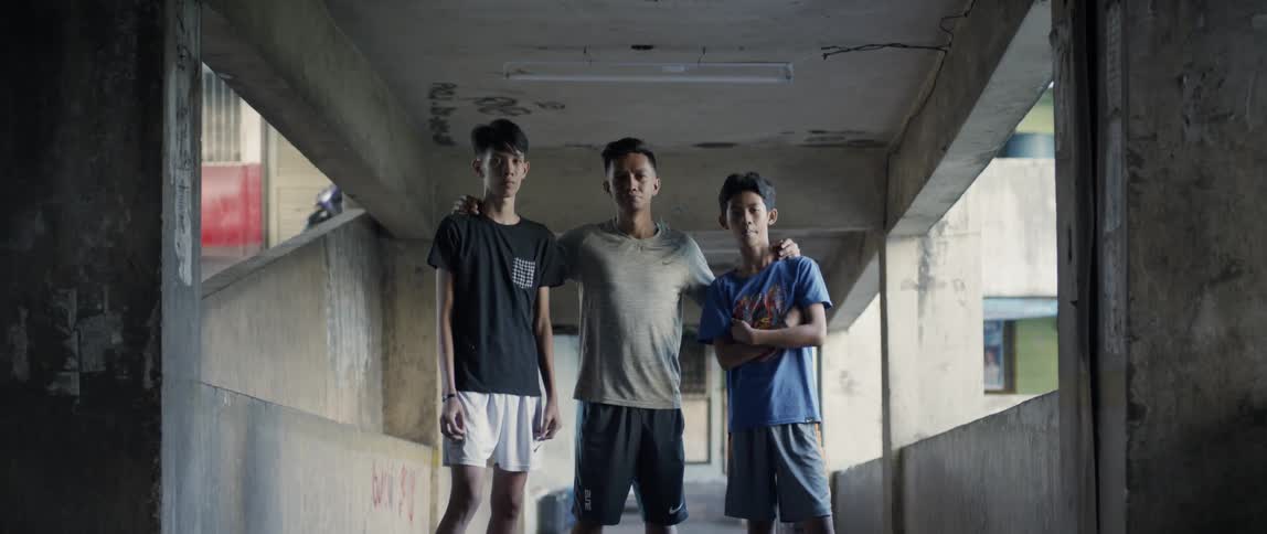 Teenagers stand in a concrete building