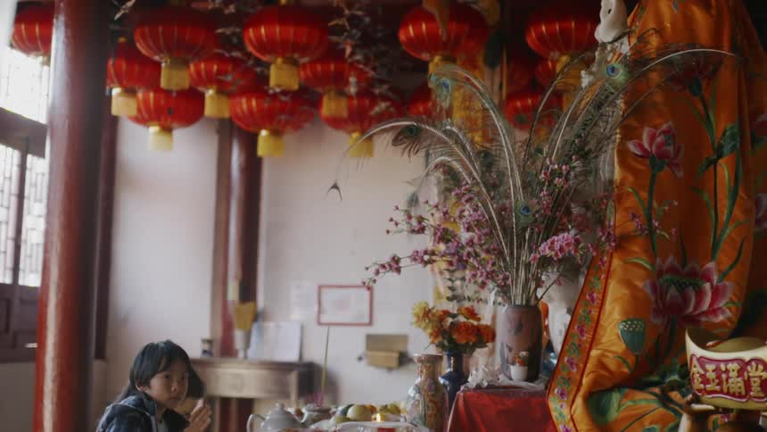A woman and child are near a table full of food