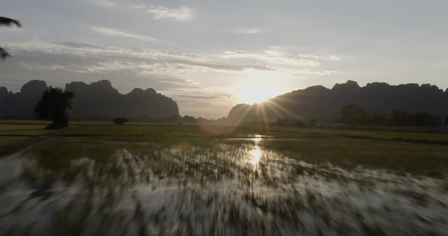 Sun rises over swampland and hills