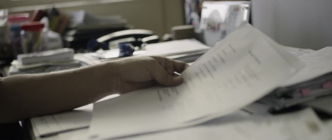 Man reads documents at a desk