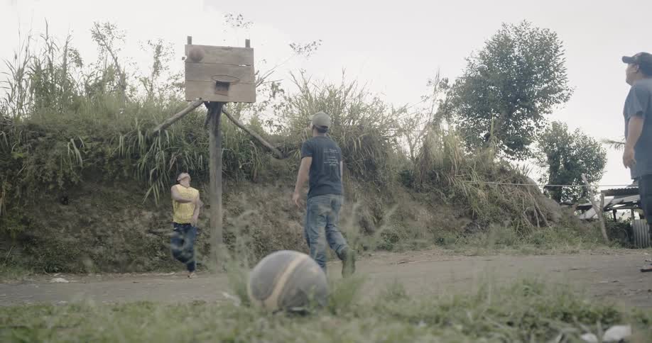 Two people play basketball together