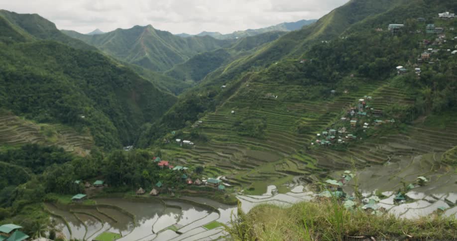 Buildings and trees sit in the valley between the mountains
