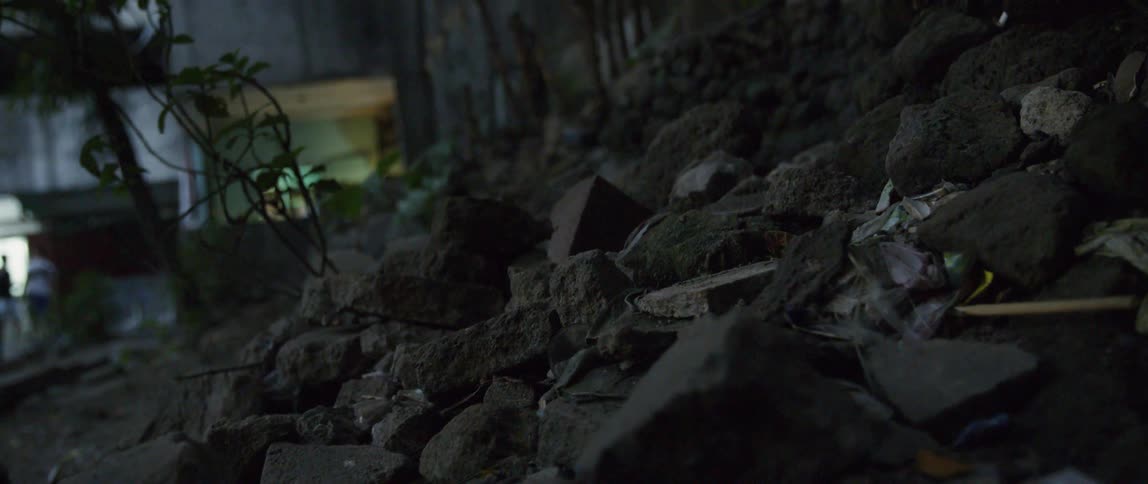 Rocks and rubble cover the ground at night