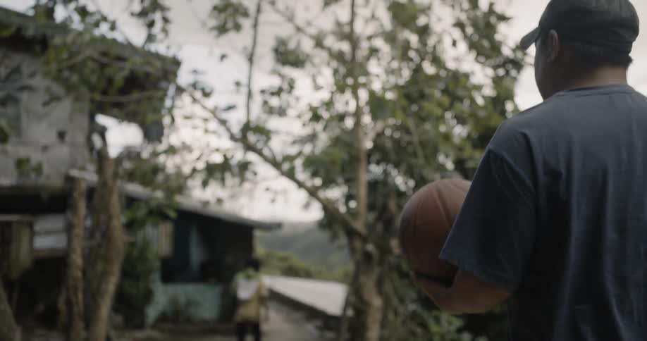 A man carries a basketball