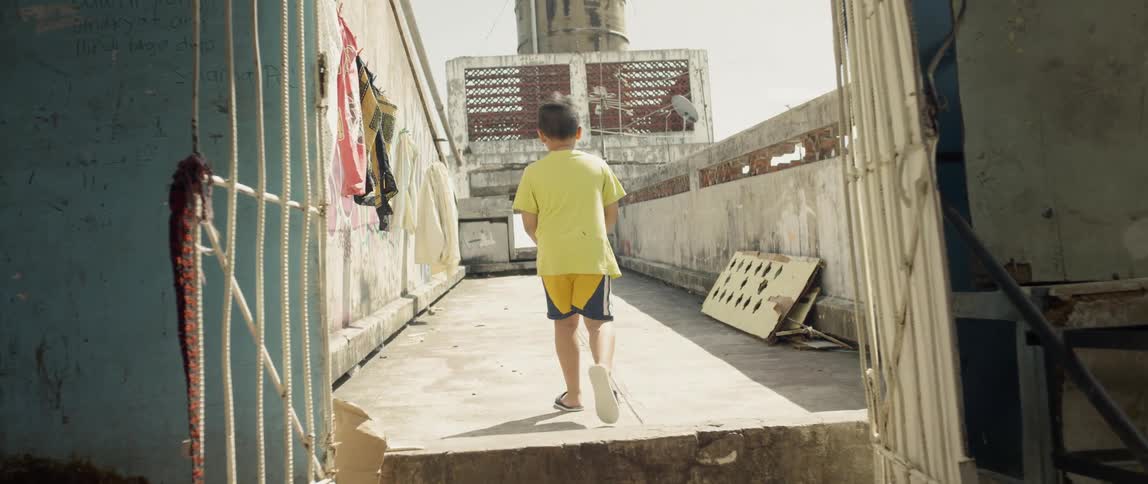The child climbs a step to get on the roof