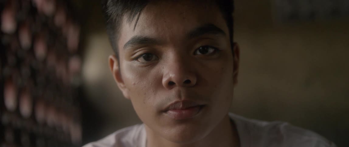 Teenage boy looks sad while staring forward