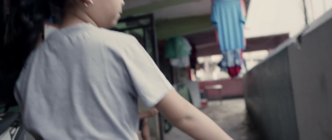 A girl carries a basketball down the hall