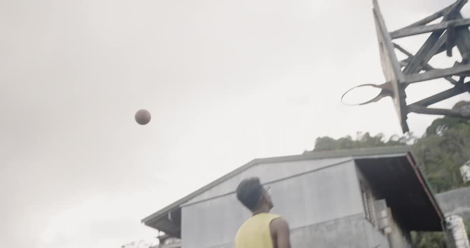 A man shoots the ball scoring from a distance