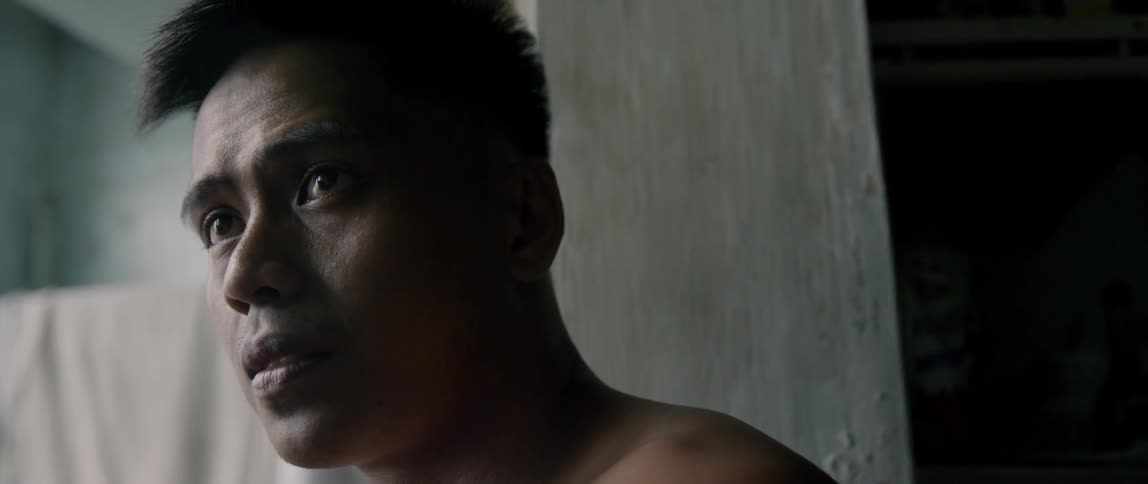 A shirtless man looks sad