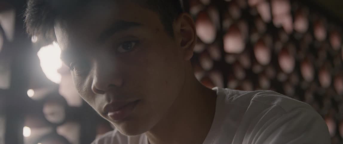 Young man raises his head as he stares ahead
