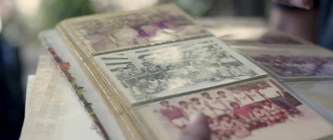 A person tabs some photographs in an album