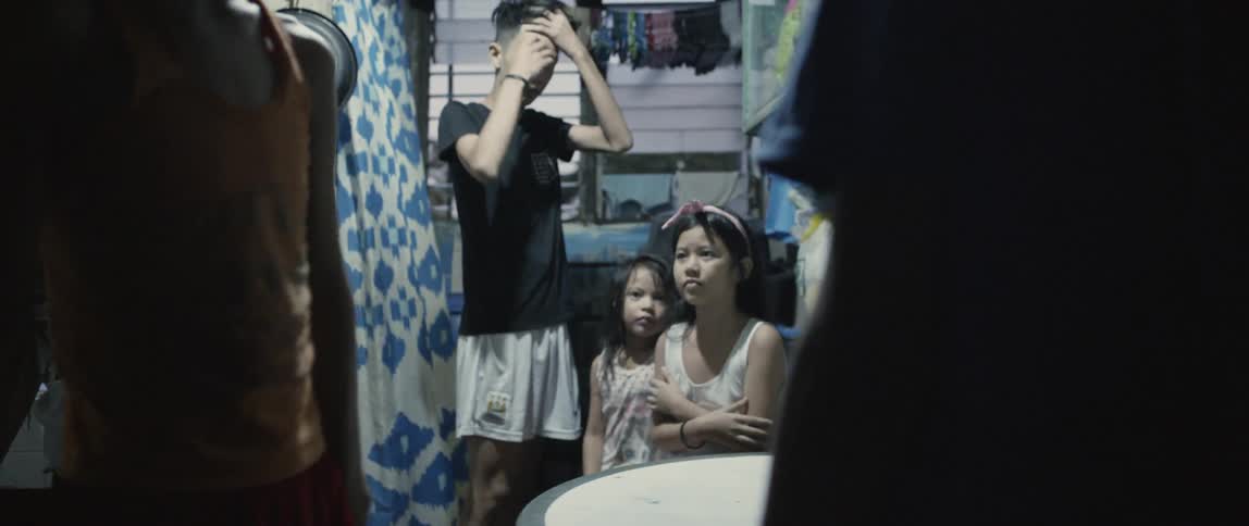 Many children stand in a small room