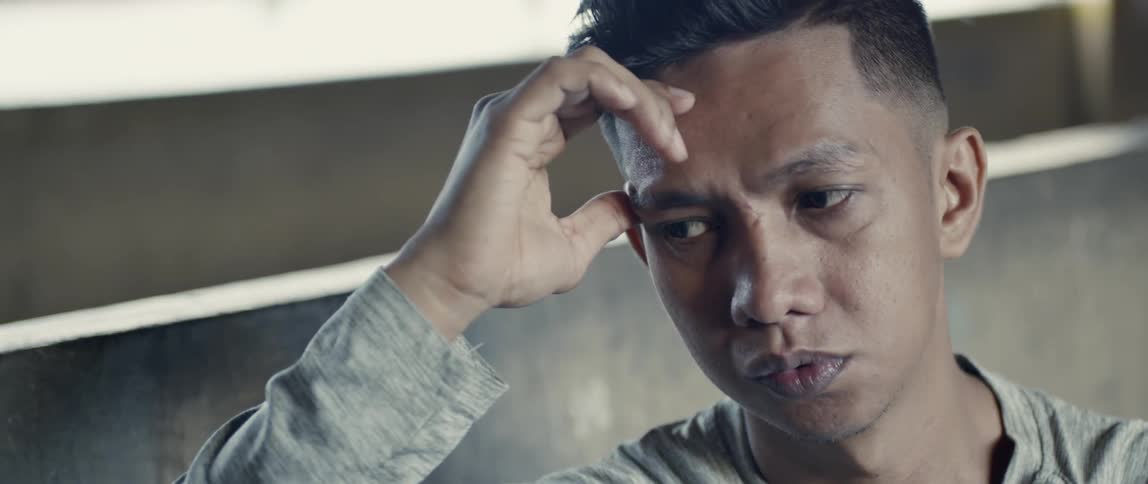 A man rubs his forehead