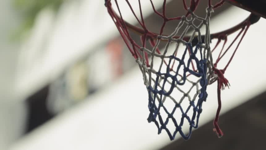 A basketball is thrown through a hoop