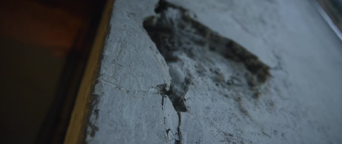 Concrete wall with a hole broken in it