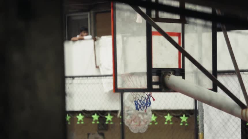 A basketball passes through the hoop