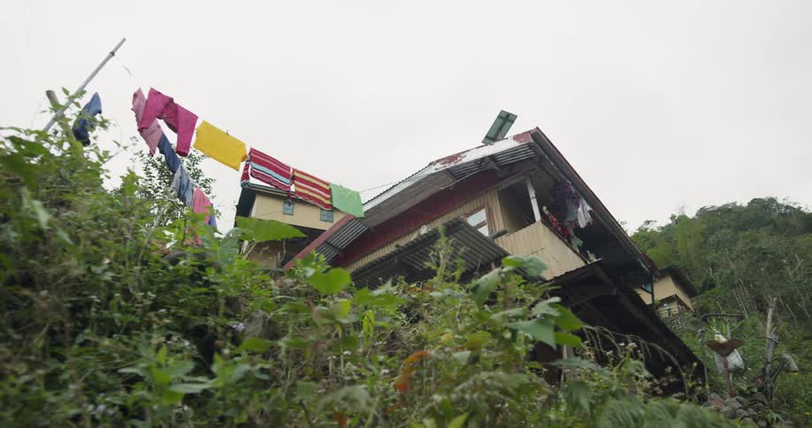 Clothes hang from a clothesline near a building
